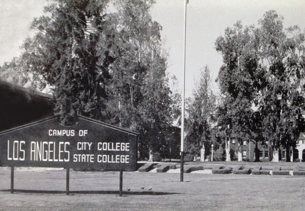 The front view of the LASC campus with a sign on the front lawn.